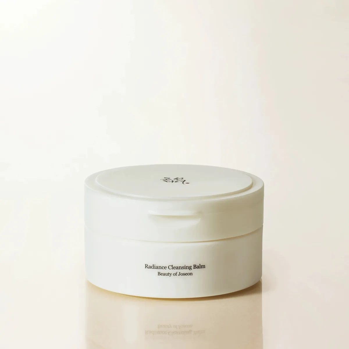 Beauty of Joseon Radiance Cleansing Balm in a frosted jar with gold-tinted balm visible through the container