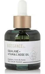 Biossance Squalane + Vitamin C Rose Oil in a clear glass dropper bottle with golden oil