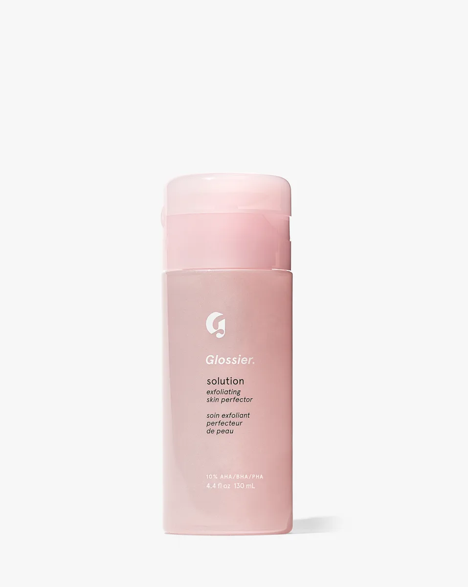 Glossier Solution Exfoliating Skin Perfector triple acid AHA BHA PHA liquid exfoliant in a glass bottle