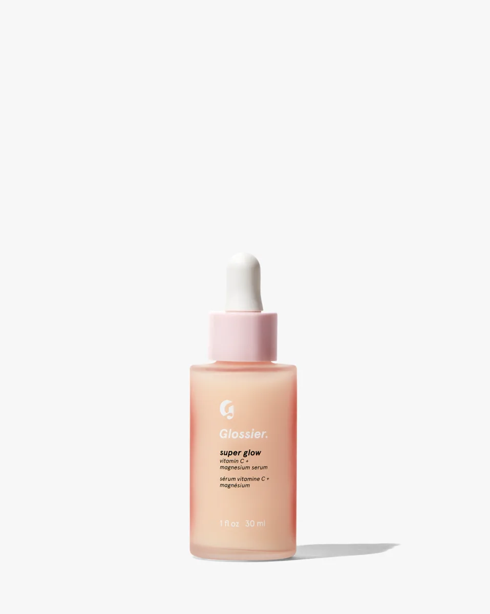 Glossier Super Glow Vitamin C Serum in a tangerine-tinted glass dropper bottle