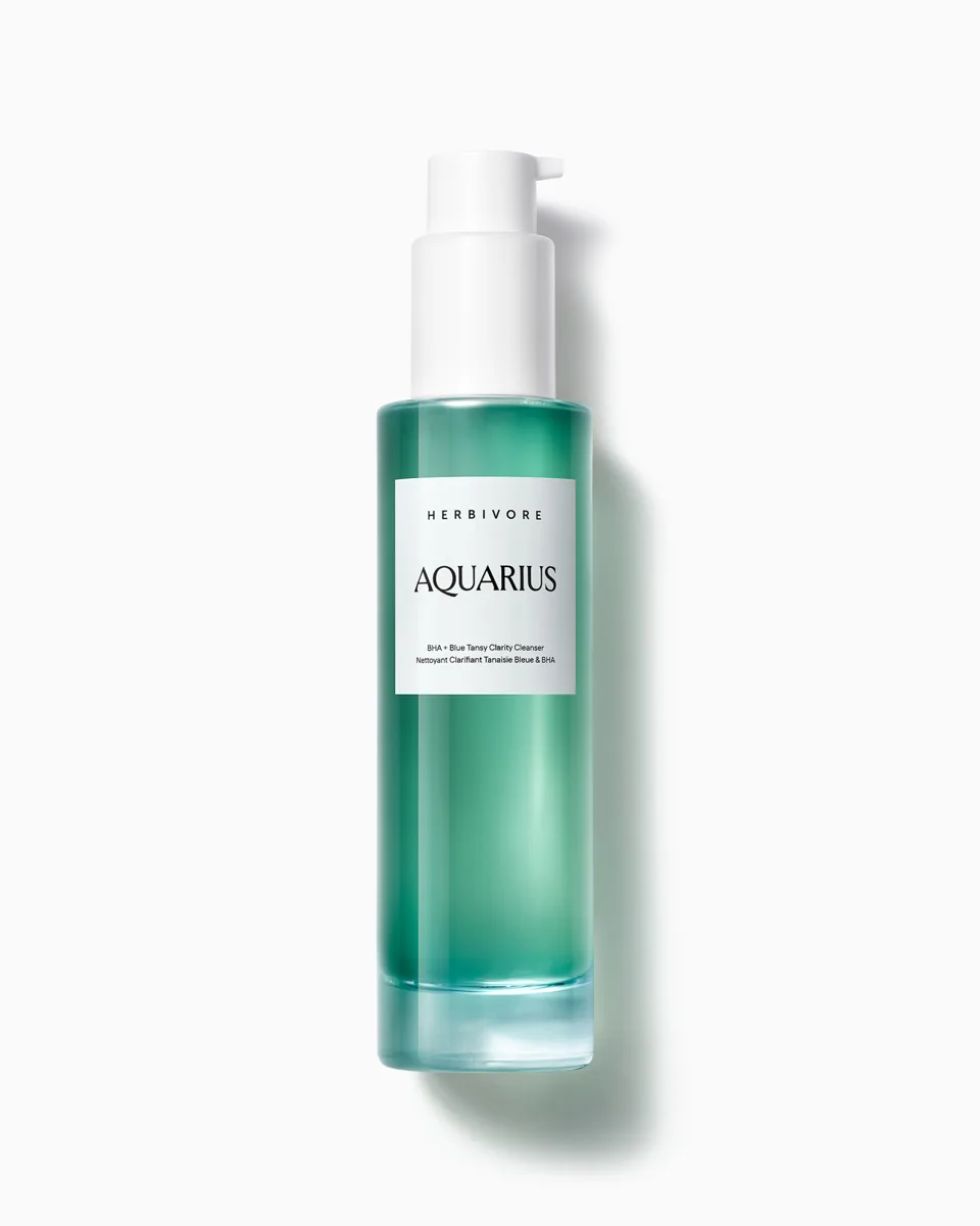 Herbivore Botanicals Aquarius BHA + Blue Tansy Clarity Facial Cleanser in clear glass bottle showing deep blue formula
