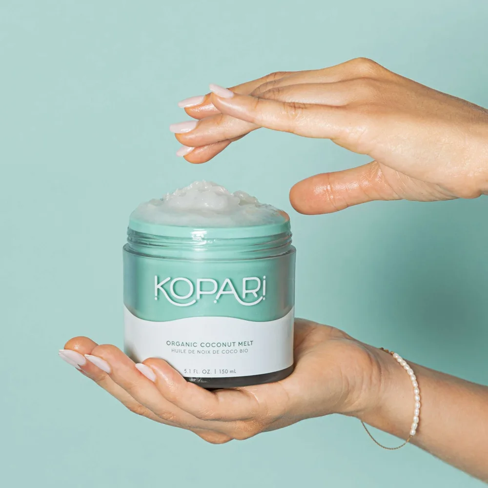 Kopari Coconut Melt in a clear glass jar showing solid white coconut oil with a screw-top lid