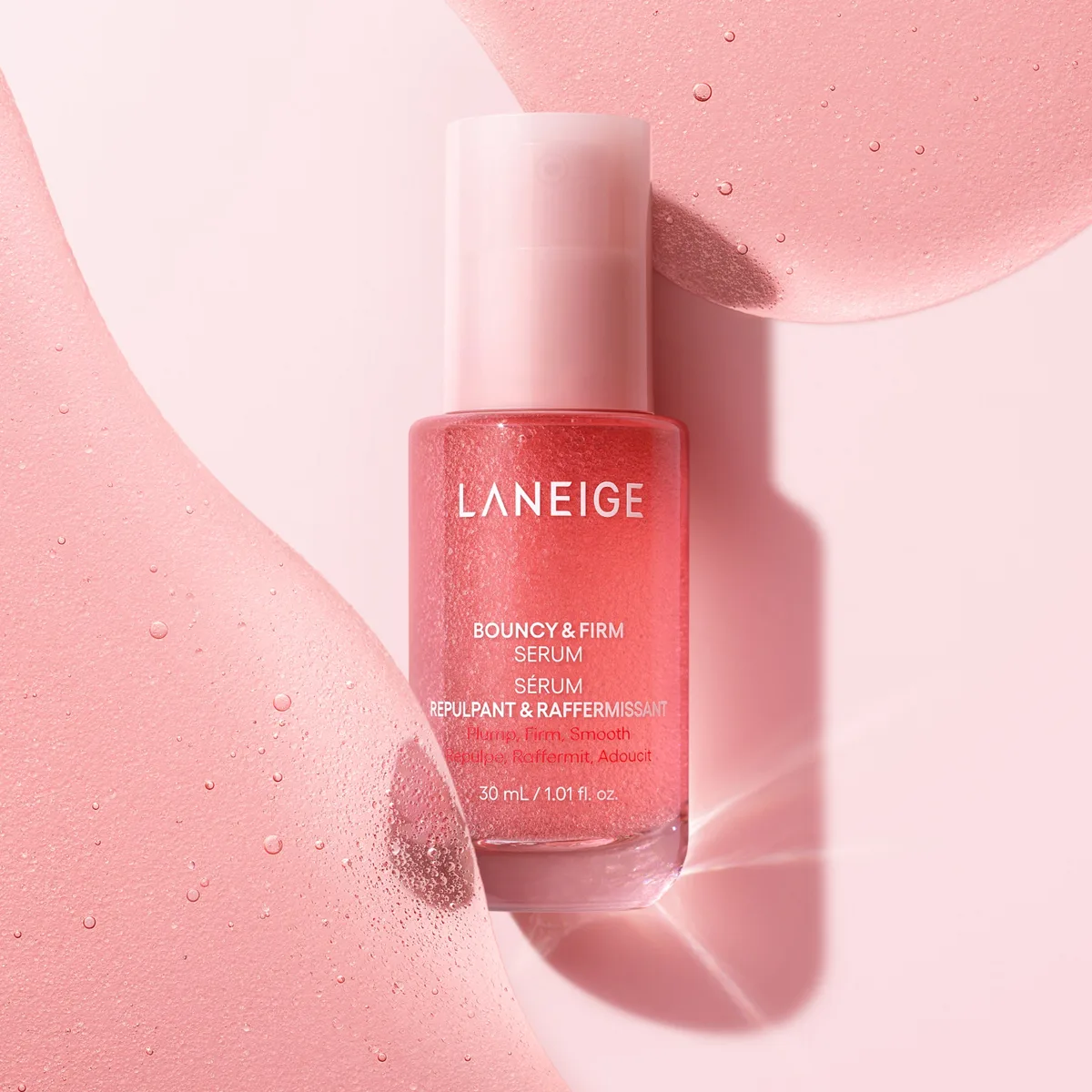 Laneige Bouncy & Firm Serum in a pink gradient glass bottle with pump dispenser
