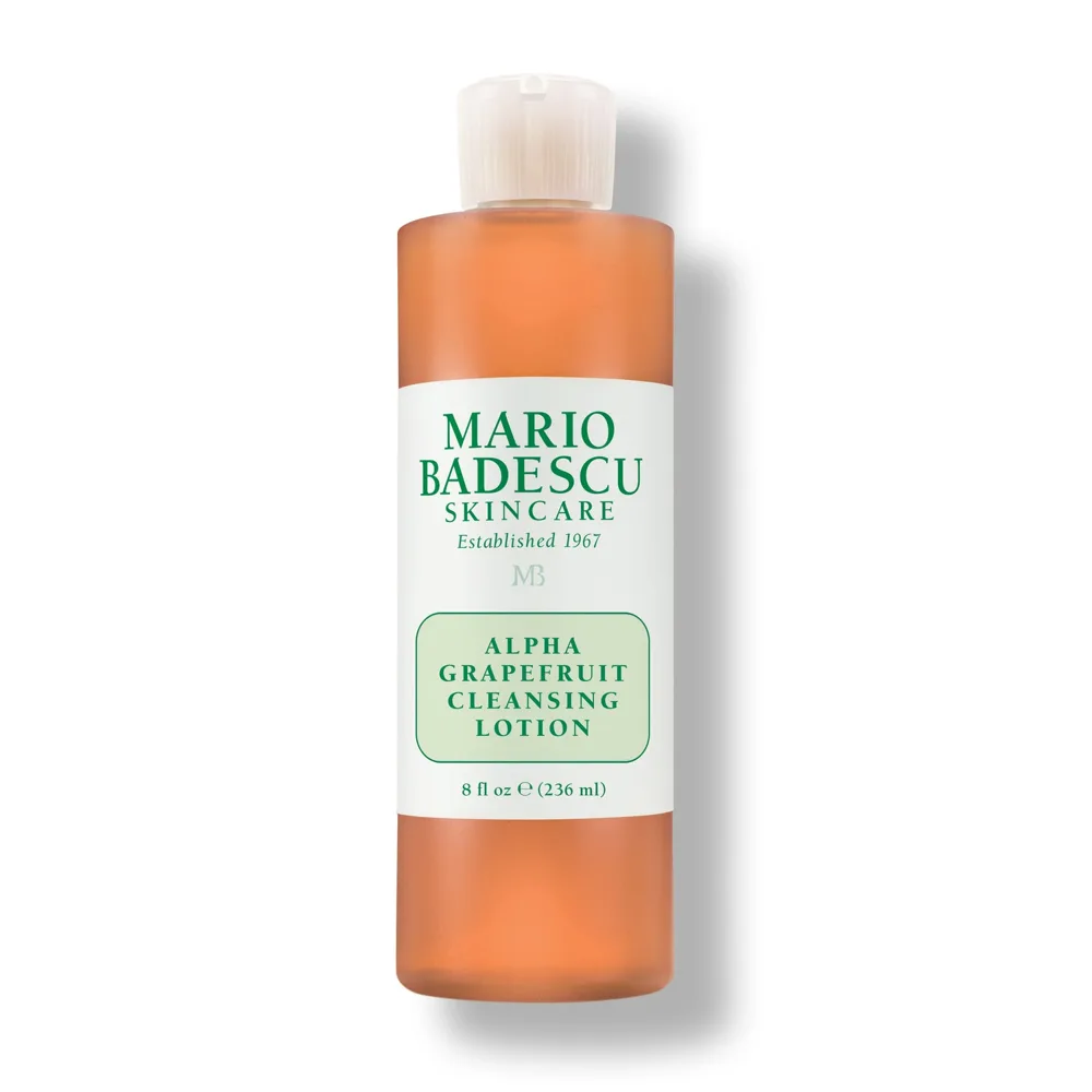 Mario Badescu Alpha Grapefruit Cleansing Lotion in a clear bottle with orange liquid