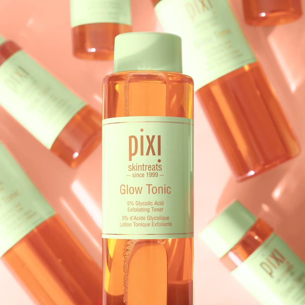 Pixi Glow Tonic 5% Glycolic Acid Exfoliating Toner bottle with signature orange liquid and green cap