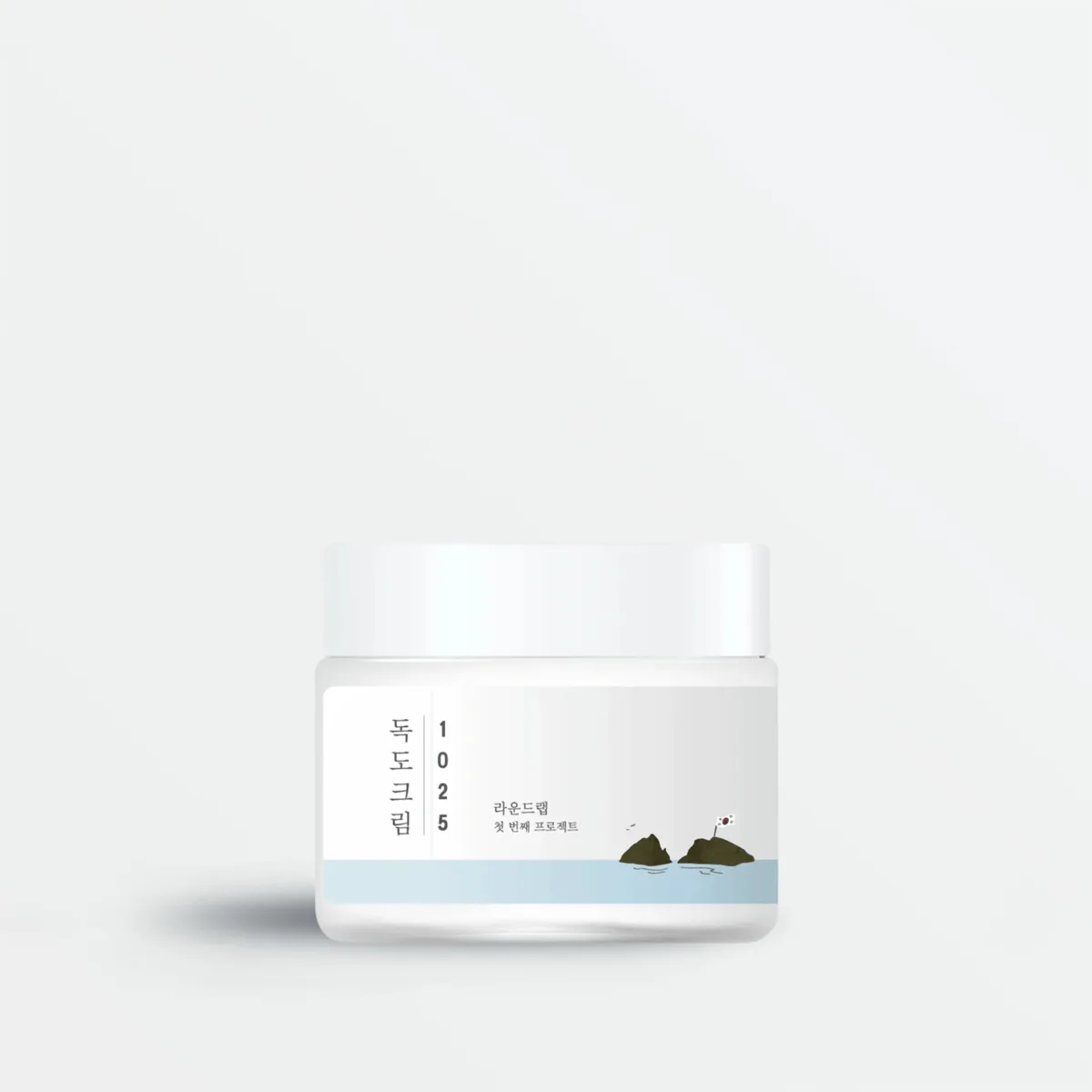 Round Lab Dokdo Cream in a white plastic jar with screw-on lid