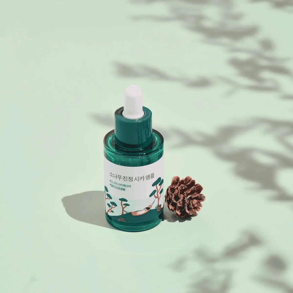 Round Lab Pine Tree Calming Cica Ampoule in a small green and white bottle with pump