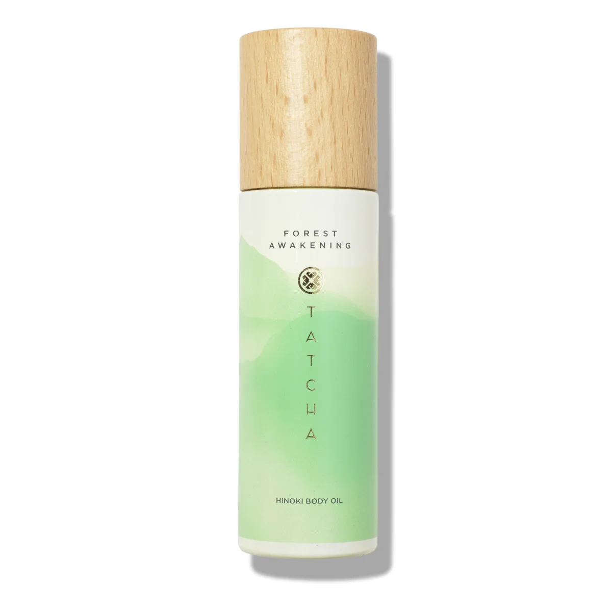 Tatcha Hinoki Body Oil glass bottle with pump dispenser in purple packaging