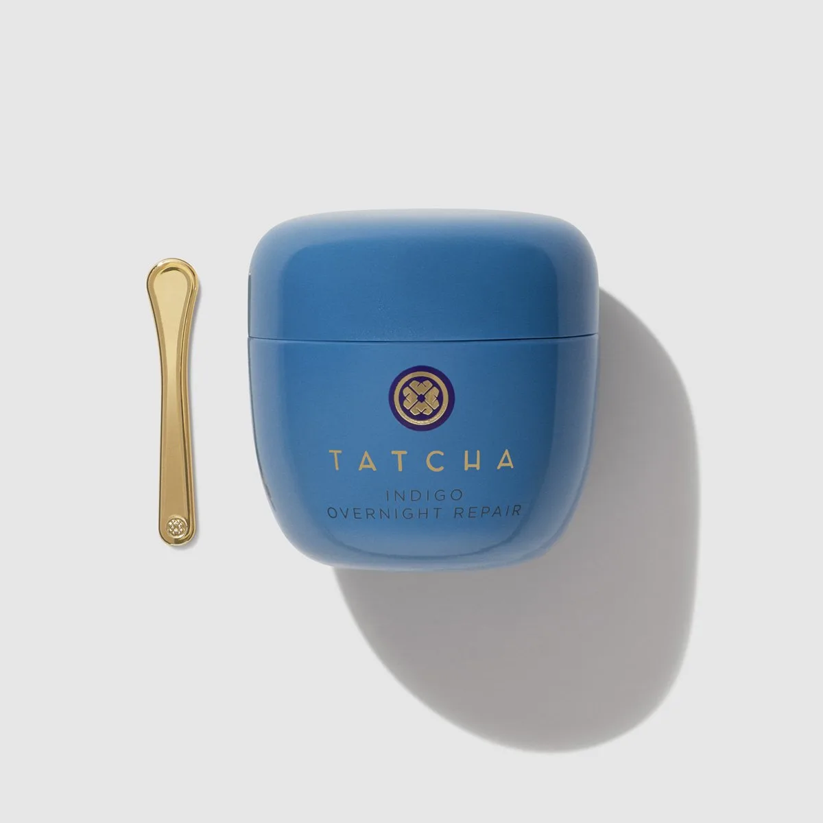Tatcha Indigo Overnight Repair Serum in Cream in a purple glass jar with gold lid