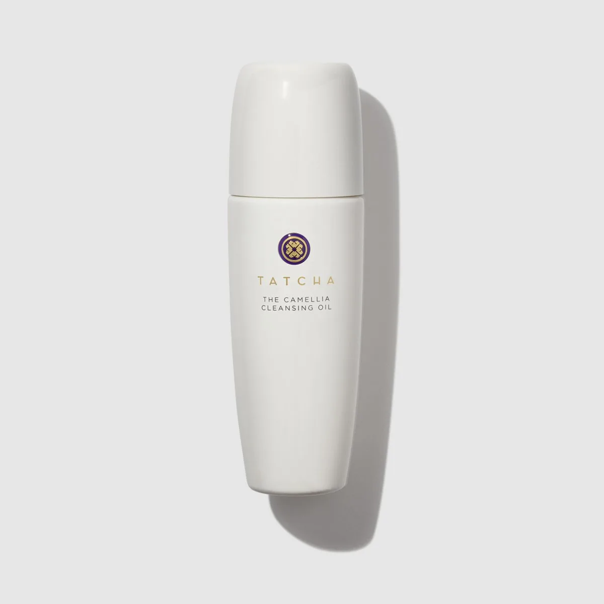 Tatcha The Camellia Cleansing Oil in a frosted glass bottle with gold pump dispenser