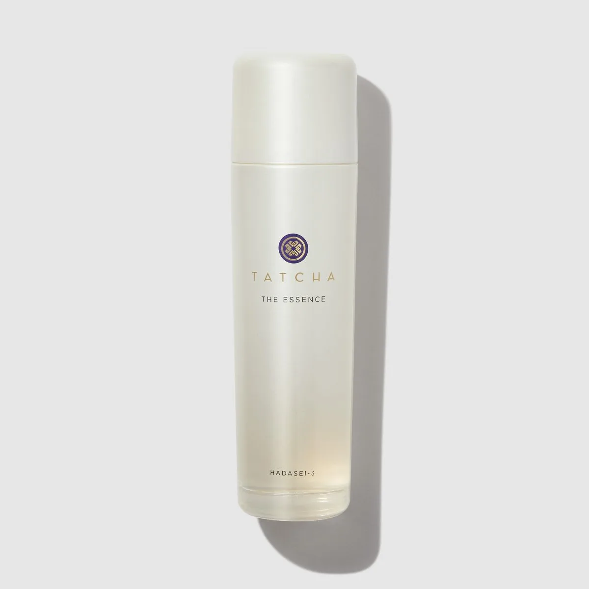 Tatcha The Essence Plumping Skin Softener in a frosted glass bottle with gold cap