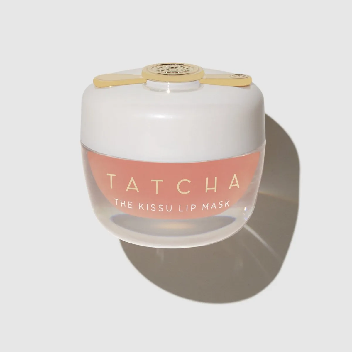Tatcha The Kissu Lip Mask in a small glass pot with gold lid and spatula applicator