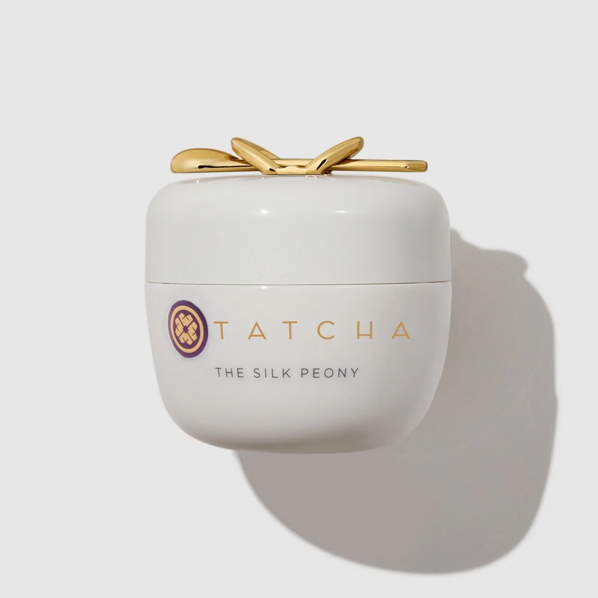Tatcha The Silk Peony Melting Eye Cream in a frosted glass jar with gold lid